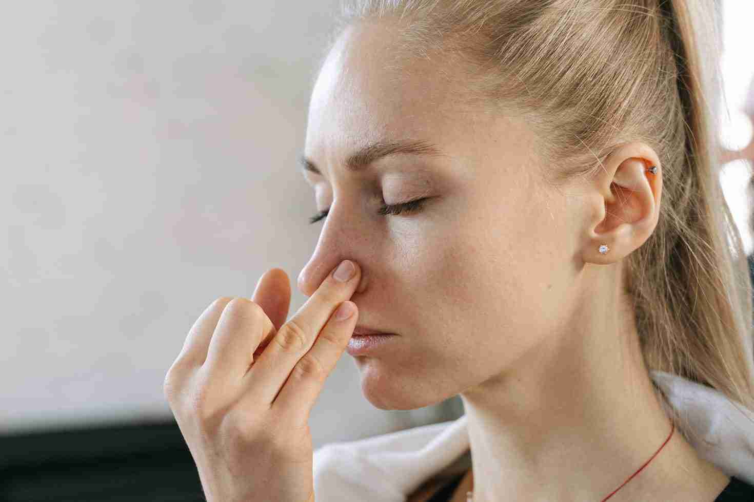 woman covering her nose