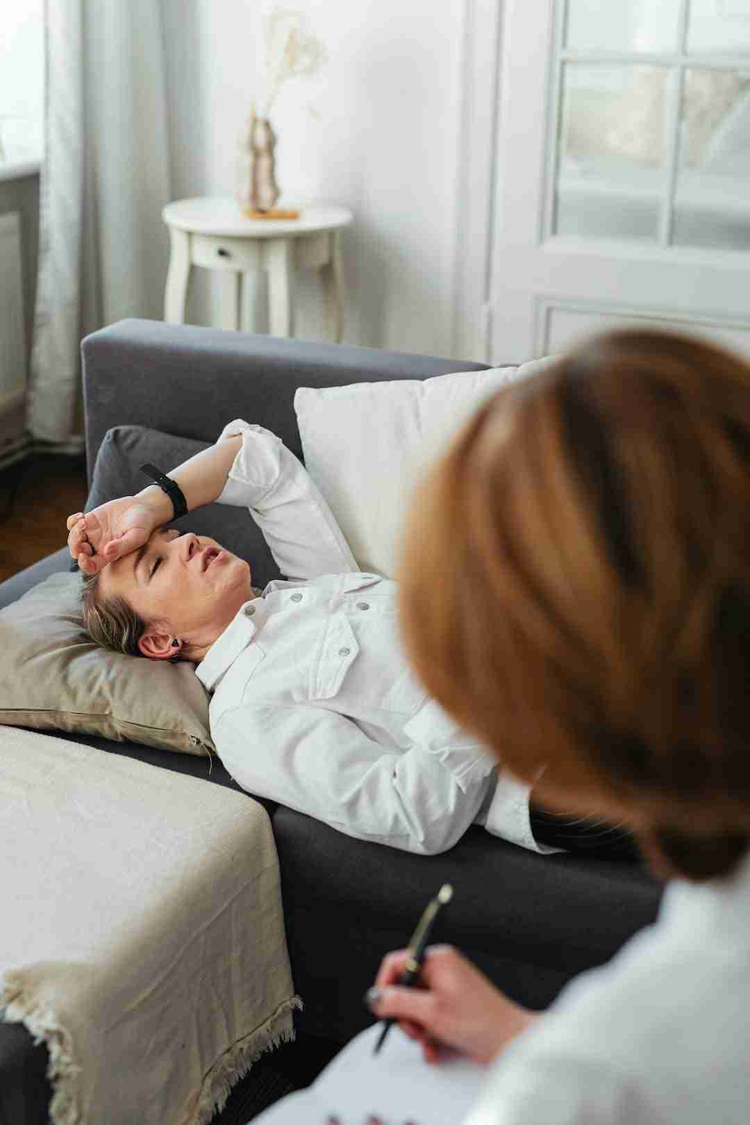 woman lying in a sofa during a therapy session