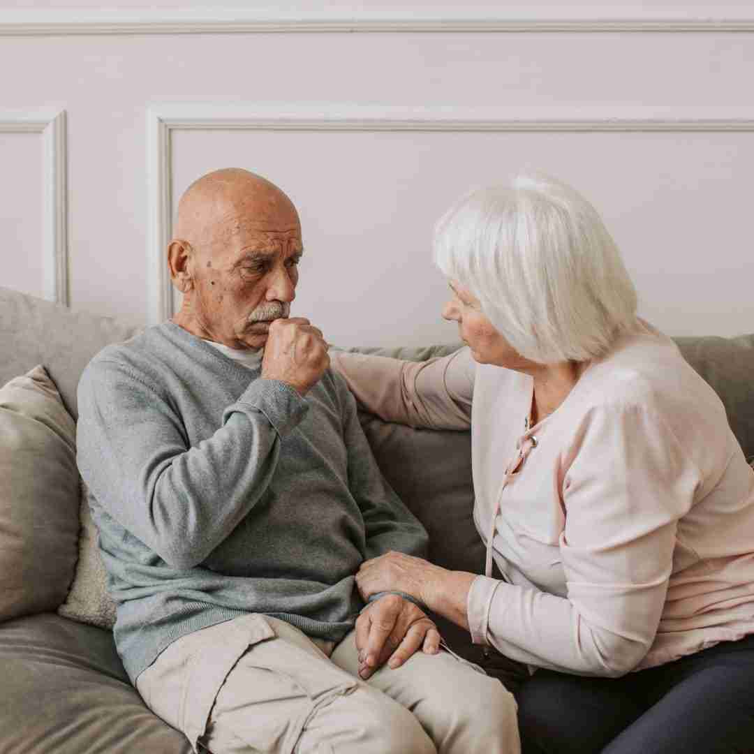 elderly sitting both on a couch