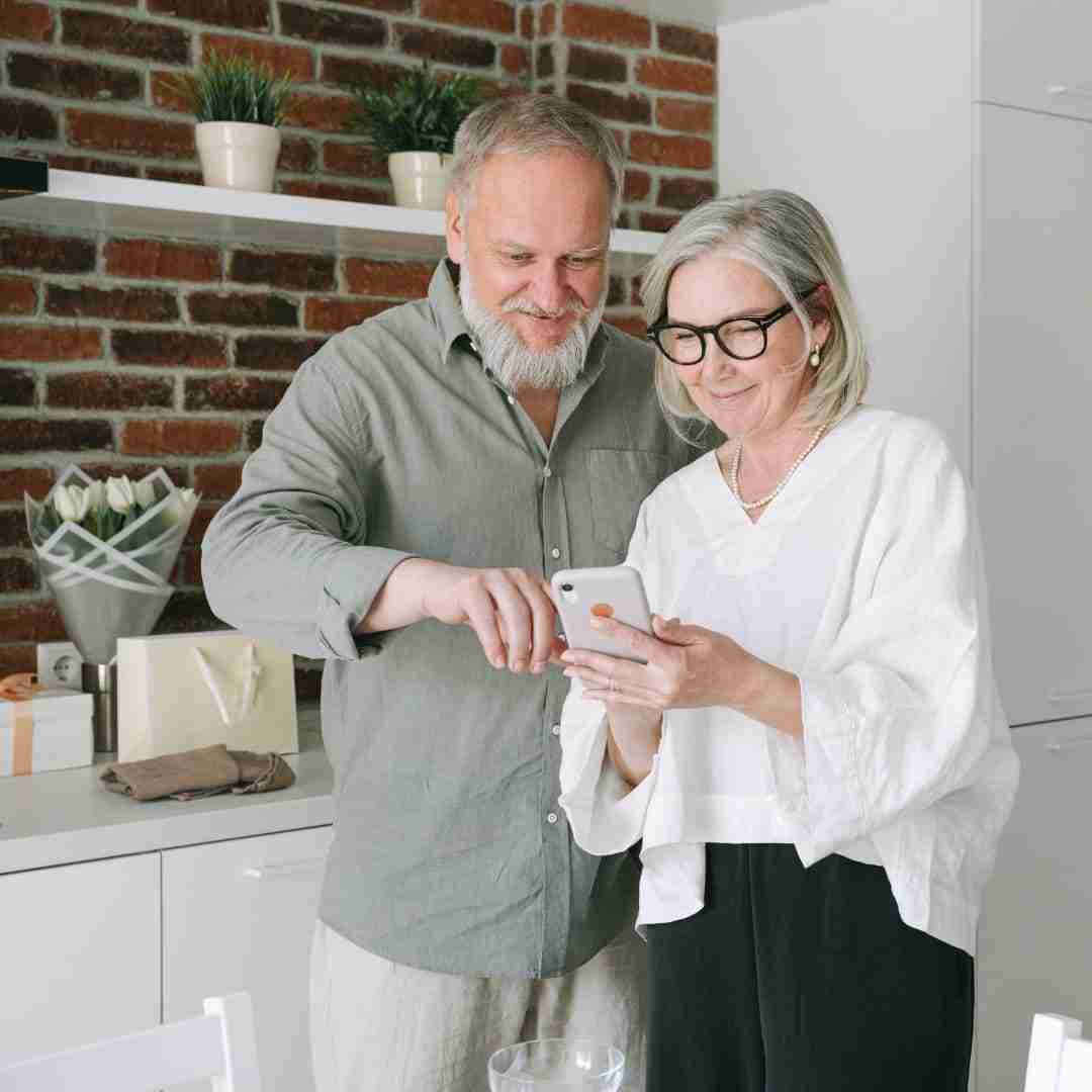 old couple checking phone