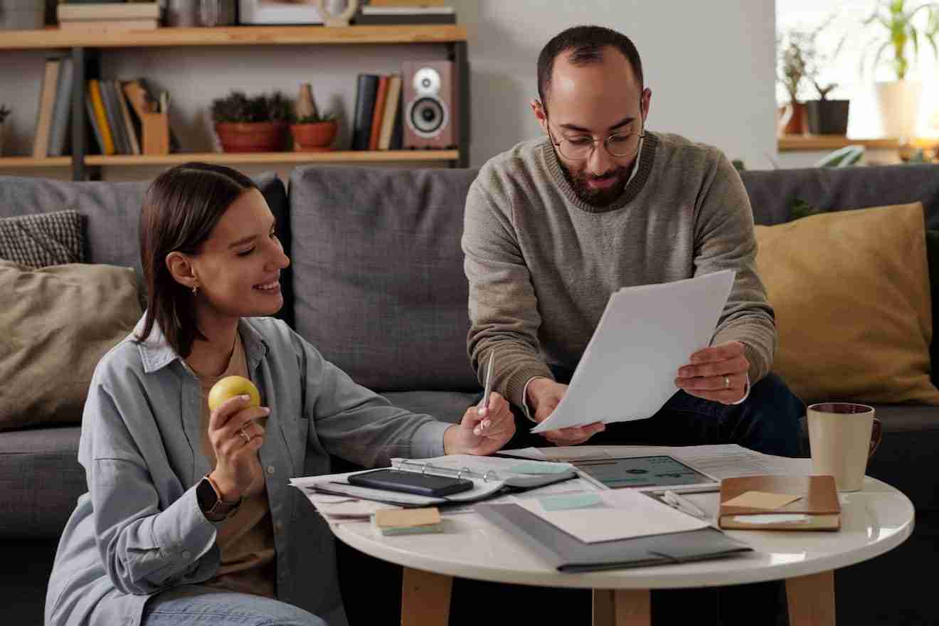 couple reading pieces of papers